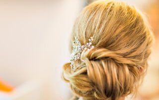 Hair stylist makes the bride before the wedding