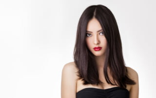 Beautiful young asian woman with long hair on white isolated background