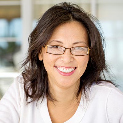 Portrait of an Asian woman laughing and smiling Portrait of an Asian woman laughing and smiling